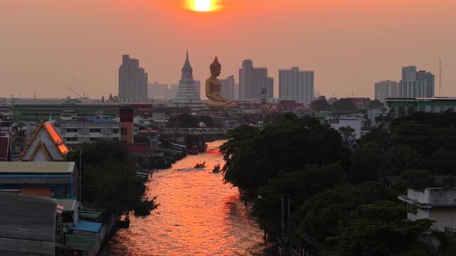 Wat paknam phasi charoen golden buddha statue sunset light aerial view travel in Bangkok Thailand
