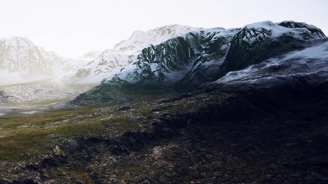 Snow covers mountain peaks while the rocky landscape stretches below. The scene captures the natural beauty of the area under clear skies, showcasing the earths raw features.