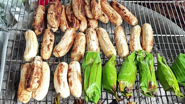 Grilled banana on grill charcoal brazier, tradition street food in Thailand