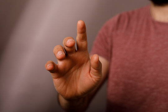 Close up of a person's hand pointing forward, signifying interaction or selection.