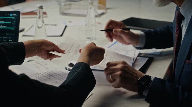 Handheld shot of Caucasian businessman signing contract and discussing oil industry documents during corporate meeting. Footage is suitable for energy sector marketing and corporate communication