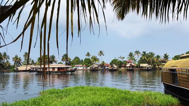 Traditional houseboats moving along the tranquil backwaters of Kerala, surrounded by lush tropical scenery, showcasing the region&rsquo;s unique waterways and tourism culture
