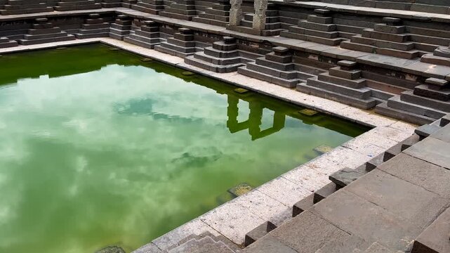 Ancient stepped tank at the UNESCO World Heritage Site of Hampi, Karnataka, India, showcasing the remarkable water management and architectural ingenuity of the Vijayanagara Empire
