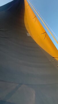 Hi-tech performance racing sailing catamaran at sunset 