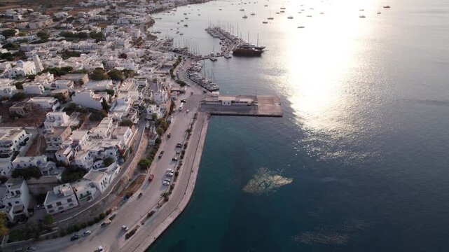 Sunrise view of Parikia Town and Harbor on Paros Island showing white buildings and blue water