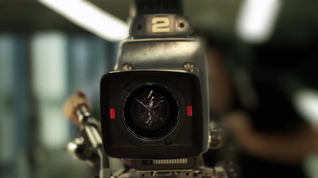 Retro TV Studio Equipment Lens Detail with Blurred Operator - 4K