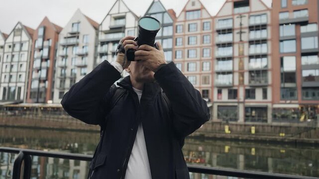 Man Photographer Capturing Gdansk Cityscape by Canal