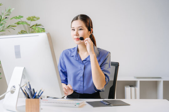 Customer Service Excellence: A professional woman with a headset on, attentively addresses a customer's needs while working at her computer in a well-lit office environment.