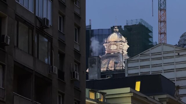 Bucharest Cityscape at Dusk: Illuminated Dome Amidst Urban Development
