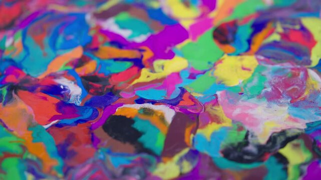 Detailed image of luminous multicolored plasticine textures shimmering. Macro view of brightly colored glossy clay showing swirling pattern layers with reflection