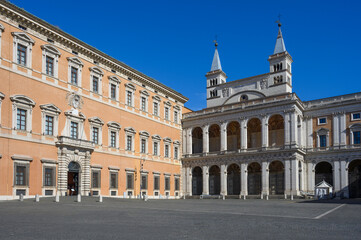 Fototapeta premium Piazza Giovanni Paolo II in Rome, Italy. Majestic facade of the Lateran Palace alongside the renaissance northern loggia and twin bell towers of the Saint John Lateran Basilica 