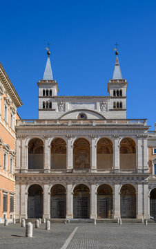 Front view of the northern side facade and loggia of blessings of the Basilica of Saint John Lateran in Rome, Italy. Majestic renaissance arcade architecture with two medieval bell towers
