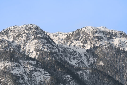 Snowy Tantalus mountain range seen from the Eagle Run dike in Brackendale during a fall season in Squamish, British Columbia, Canada