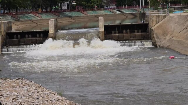 The floodgate is releasing a large volume of water.