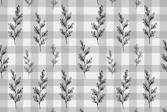 Hand drawn delicate black branches layered over a light gray gingham plaid background to create a cozy seamless pattern.
