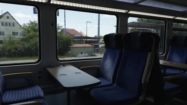 Classic German train travel experience showcasing an empty passenger compartment with a convenient table setup for European summer rail tours