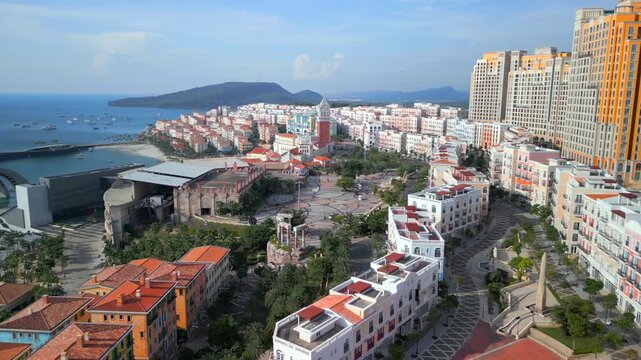 Aerial view of Sunset Town in Phu Quoc, Vietnam. Colorful Mediterranean-style architecture, waterfront promenade, marina and modern resorts create a vibrant coastal cityscape.