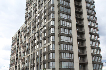 Obraz premium a modern beautiful residential building with a red facade against a clear blue sky 