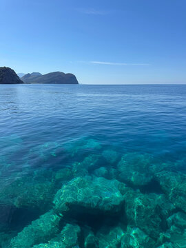 Beautiful blue sea with rocky seabed and sky vertical.