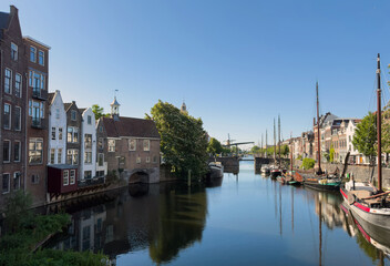 Naklejka premium Historic Delfshaven canal with moored boats on a sunny spring day in Rotterdam Netherlands