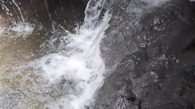 Close-up of Waterfall Water Flowing Over Rocky Surface