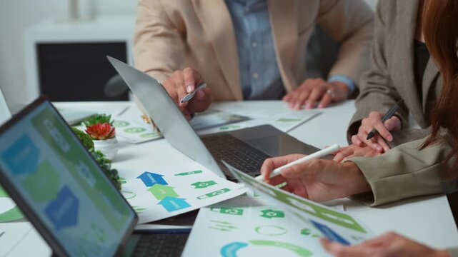 Business team collaborating on an environmental project, discussing corporate sustainability and social responsibility with esg reports and data analysis for a green and eco friendly business plan