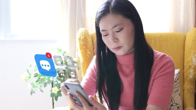 Sitting on an armchair, a middle aged Asian woman scrolls user messages on phone, with a 3D tracked text message balloon and multiple user profile pop ups.