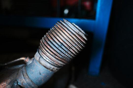 An automotive diesel particulate filter, exhaust emissions control component, vehicle exhaust system detail. Car fumes and emissions control. catalytic converter system.