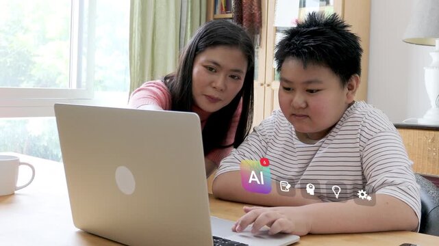 East Asian mother in her 40s guides her young son on a laptop at a home desk, showing 3D tracked virtual AI notification assistant and brain gear pop up charts.