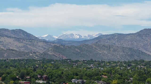 Aerial of snow capped Mount Evans in Rocky Mountains in summer from Denver Colorado suburbs