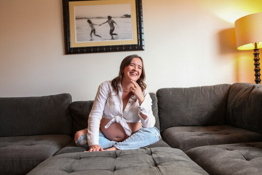 Casual Portrait Of Expecting Mom Laughing