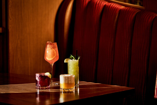 Elegant Craft Cocktails in Moody Luxury Lounge Interior. 