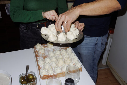 A young woman and a young man are cooking