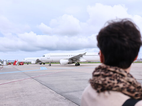 Woman watching airplanes at Bucharest international airport