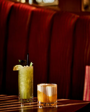 Elegant Cocktails in Moody Lounge With plush Booth Seating