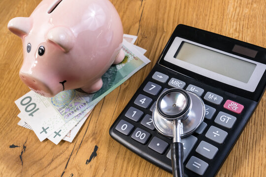 Stethoscope, calculator, piggy bank - health care costs concept