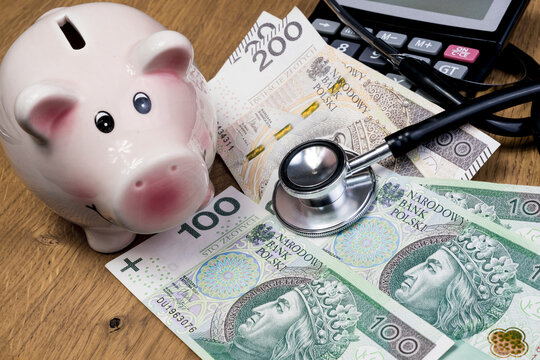 Stethoscope, calculator, piggy bank - health care costs concept