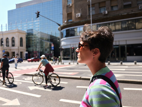 Woman with short hair walking city street in Bucharest