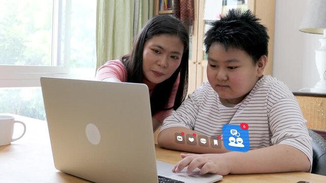 East Asian mother and her young son browse online community on laptop, surrounded by 3D tracked chat bubble, love heart, and message envelope notification pop ups.