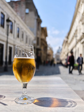 Beer glass on outdoor cafe table in Bucharest