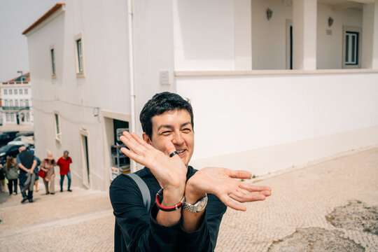 Person Shows Hands in the Street With People Nearby
