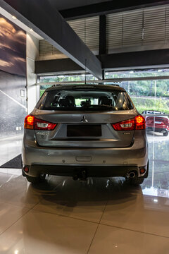 Grey Mitsubishi ASX centered rear view, Compact SUV in dealership showroom