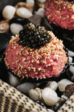 Close up shot of steak tartar ball with caviar