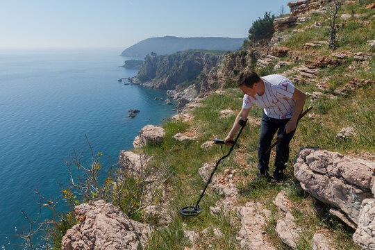 Man with metal detector in nature