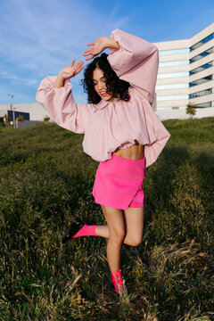 Joyful woman dancing outdoors 