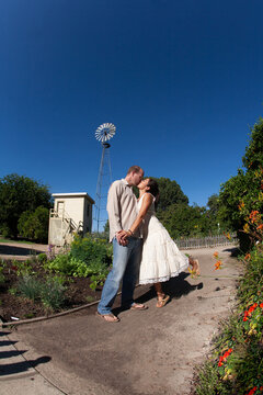 Couple Kisses In A Garden