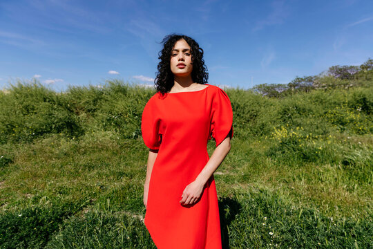 Woman standing in green field