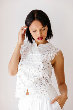 Woman wearing white lace cheongsam style top