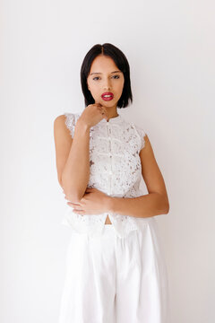 Woman posing in white outfit