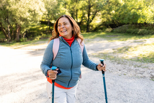 Happy senior woman enjoying active outdoor nature walk